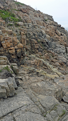Lee takes an upward panarama photo of the cliffs