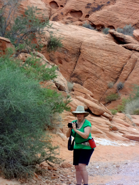 Karen Duquette by cliffs at Petroglyph Canyon trail