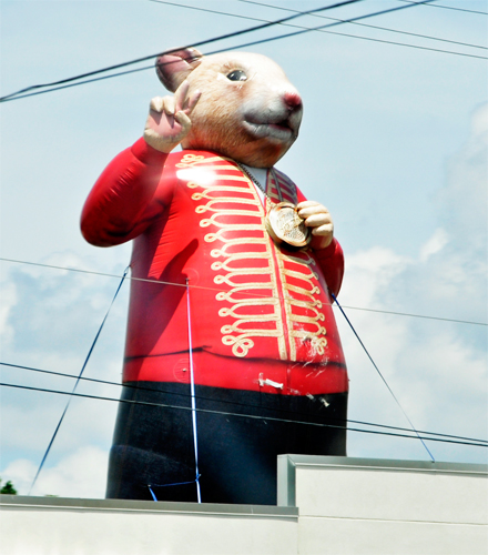 A giant mouse giving the peace sign