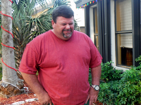 John closes his eyes as snow gets thrown at him.