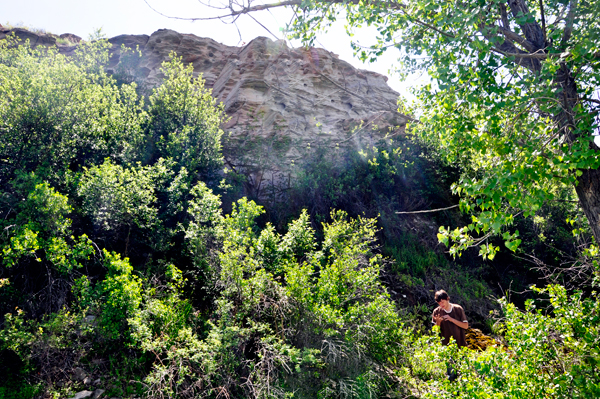dude getting the mud out of his fingernails.