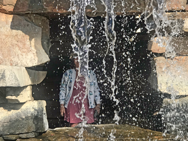 Karen Duquette behind the waterfall